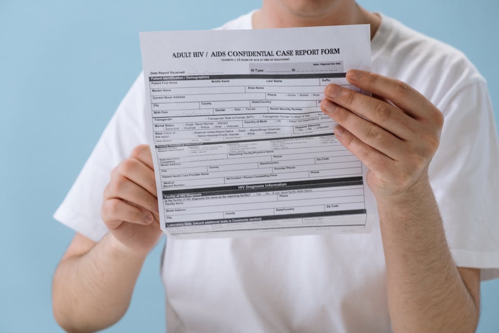 Person holding confidential HIV/AIDS case report form, symbolizing health awareness and privacy.