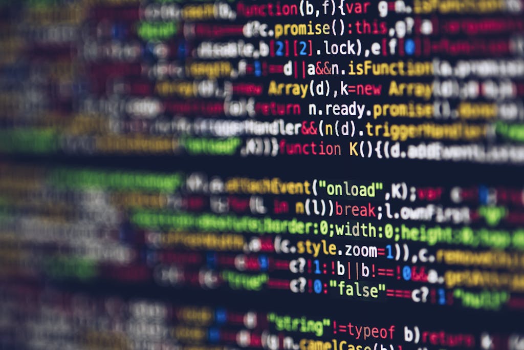 Vivid, blurred close-up of colorful code on a screen, representing web development and programming.